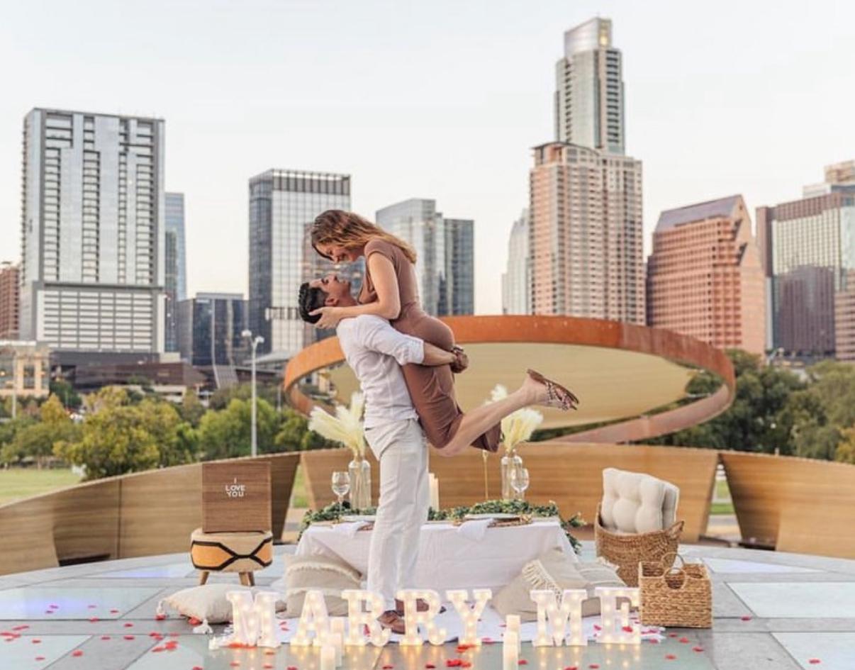 A romantic proposal picnic setup by Graceful Gatherings with the Austin skyline in the background